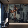 Fototapeta Wysportowana kobieta podnosząca sztangę