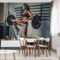 Fototapeta Wysportowana kobieta podnosząca sztangę
